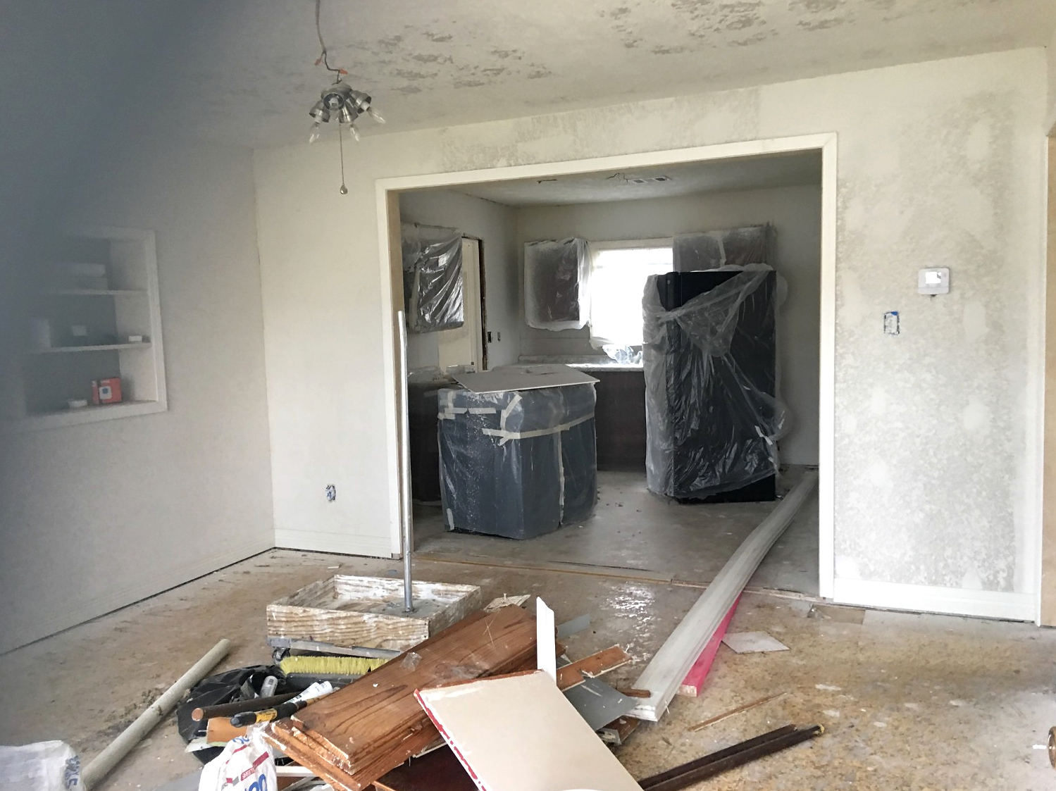 Residential living and kitchen area during renovation before final flooring and finishes